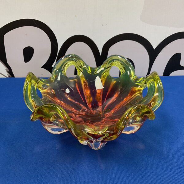 Vibrant Murano art glass bowl with yellow and orange swirls.