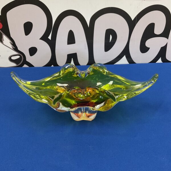Vibrant Murano glass bowl with yellow and orange swirls.