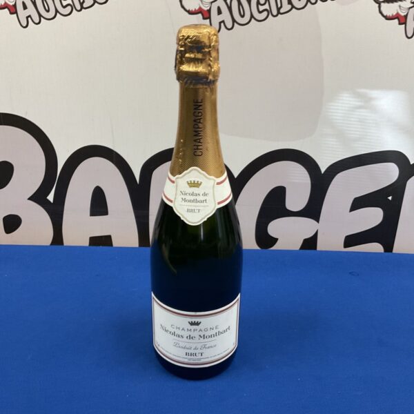 Bottle of Nicolas de Montbarl Brut Champagne with label visible.