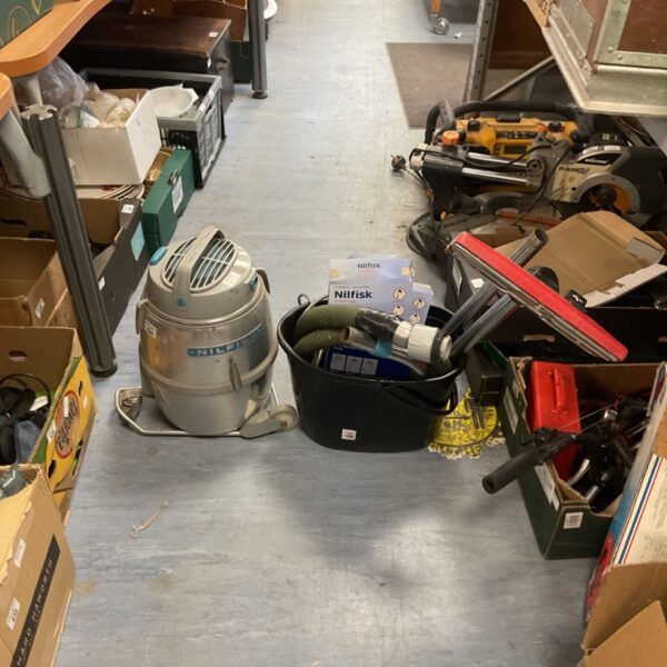Nilfisk GM80 industrial vacuum cleaner with attachments and accessories.