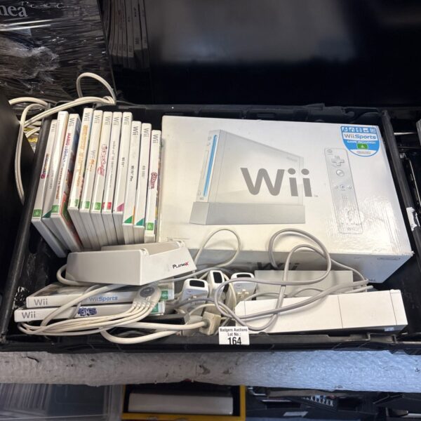 Nintendo Wii console bundle with games and accessories displayed.