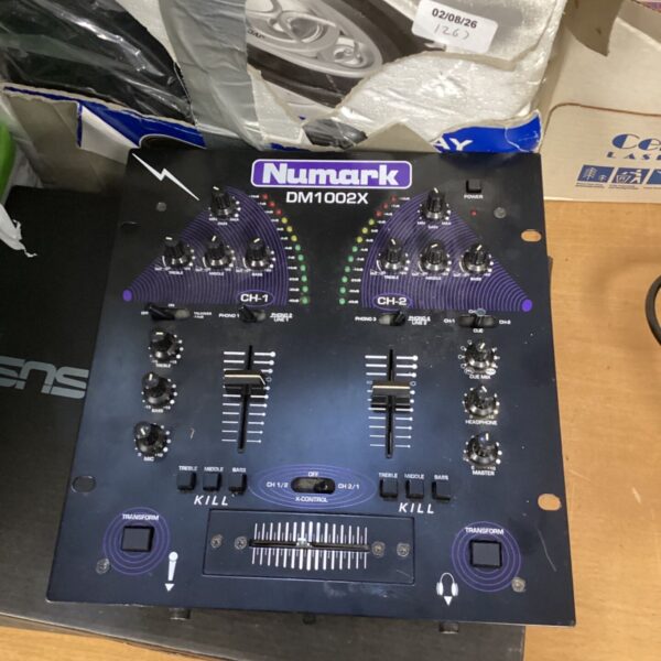 Vintage Numark DM1002x DJ mixer with controls visible.
