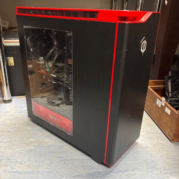 Black NZXT H440 gaming PC case with side panel window.