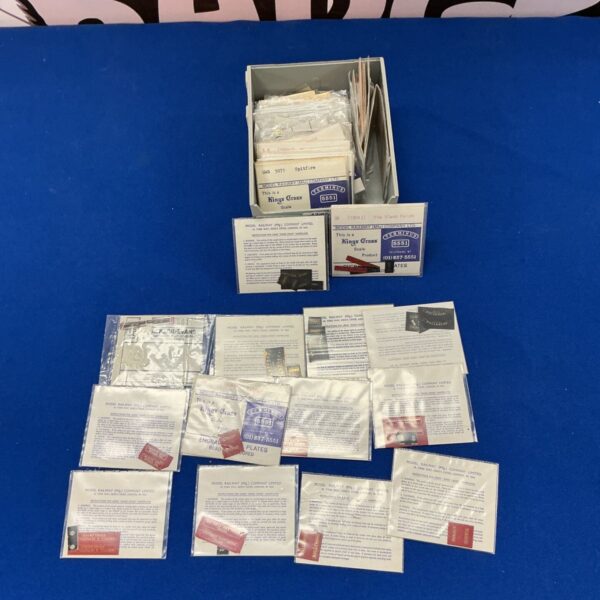 Vintage O gauge train name and station plates collection.