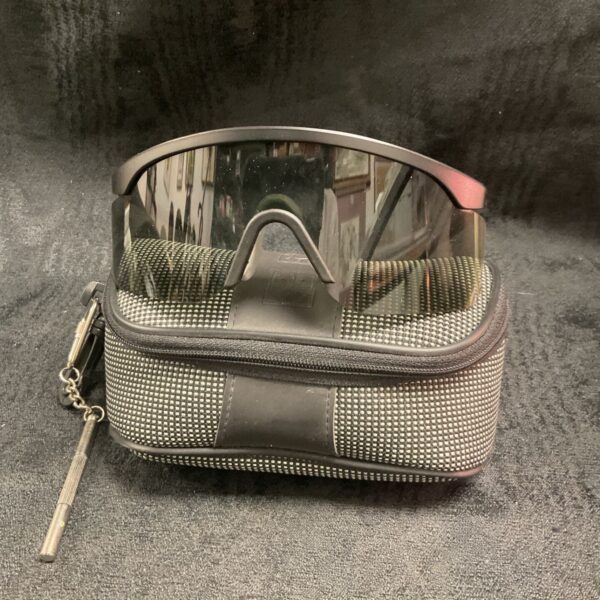 Oakley sunglasses in a grey and black case.