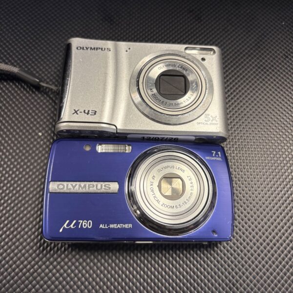Two Olympus digital cameras, X-43 and U760, vintage compact cameras.
