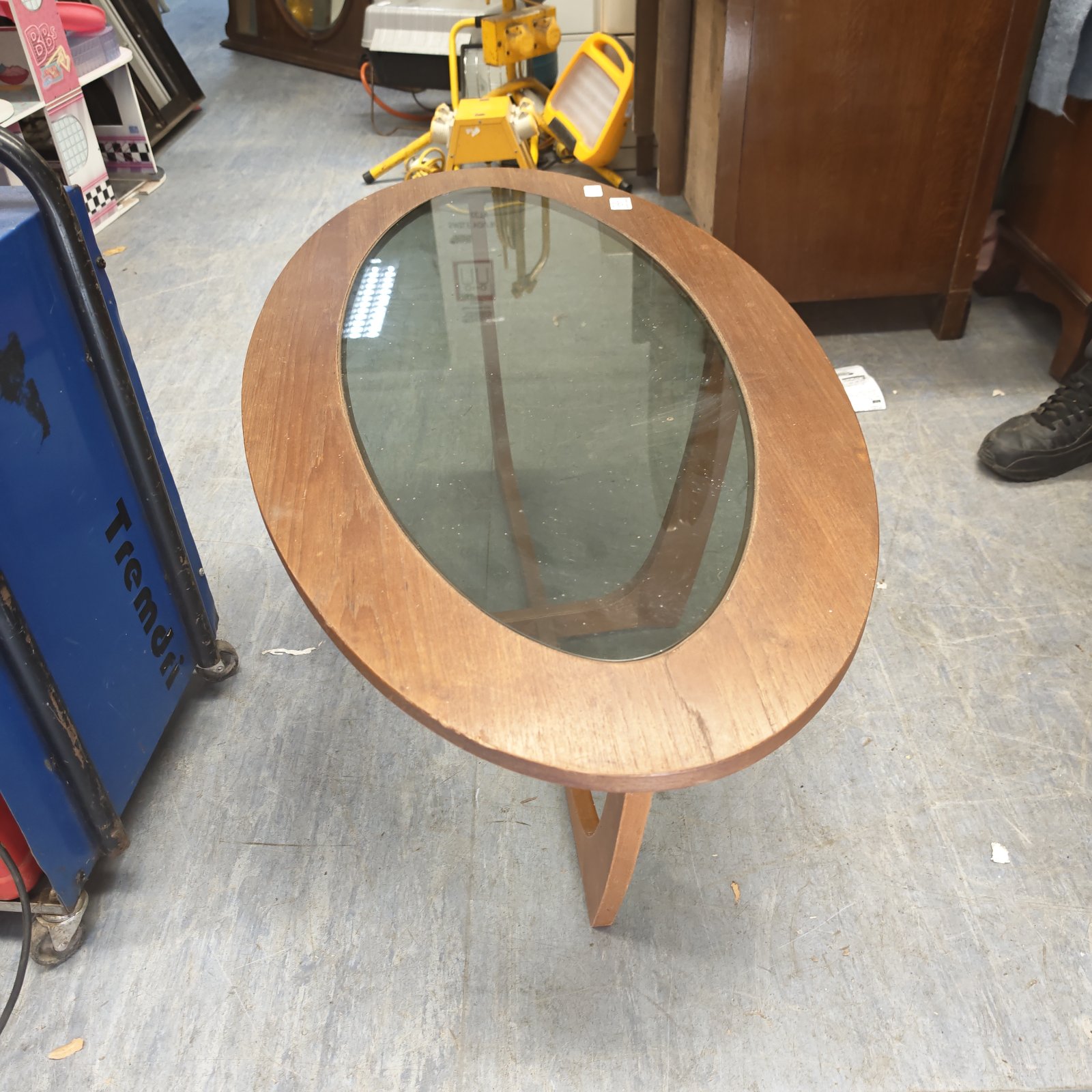 Vintage oval glass top coffee table with wooden frame.