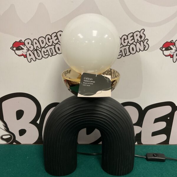Black and gold Ozias table lamp with a vintage aesthetic.