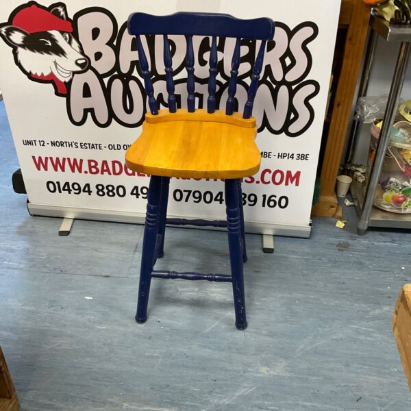 Rustic painted pine kitchen stool with three legs.