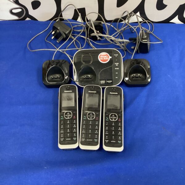 Lot of three Panasonic wireless phones and charging docks.