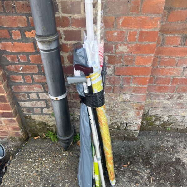 Job lot of vintage parasols, walking stick and crutch.