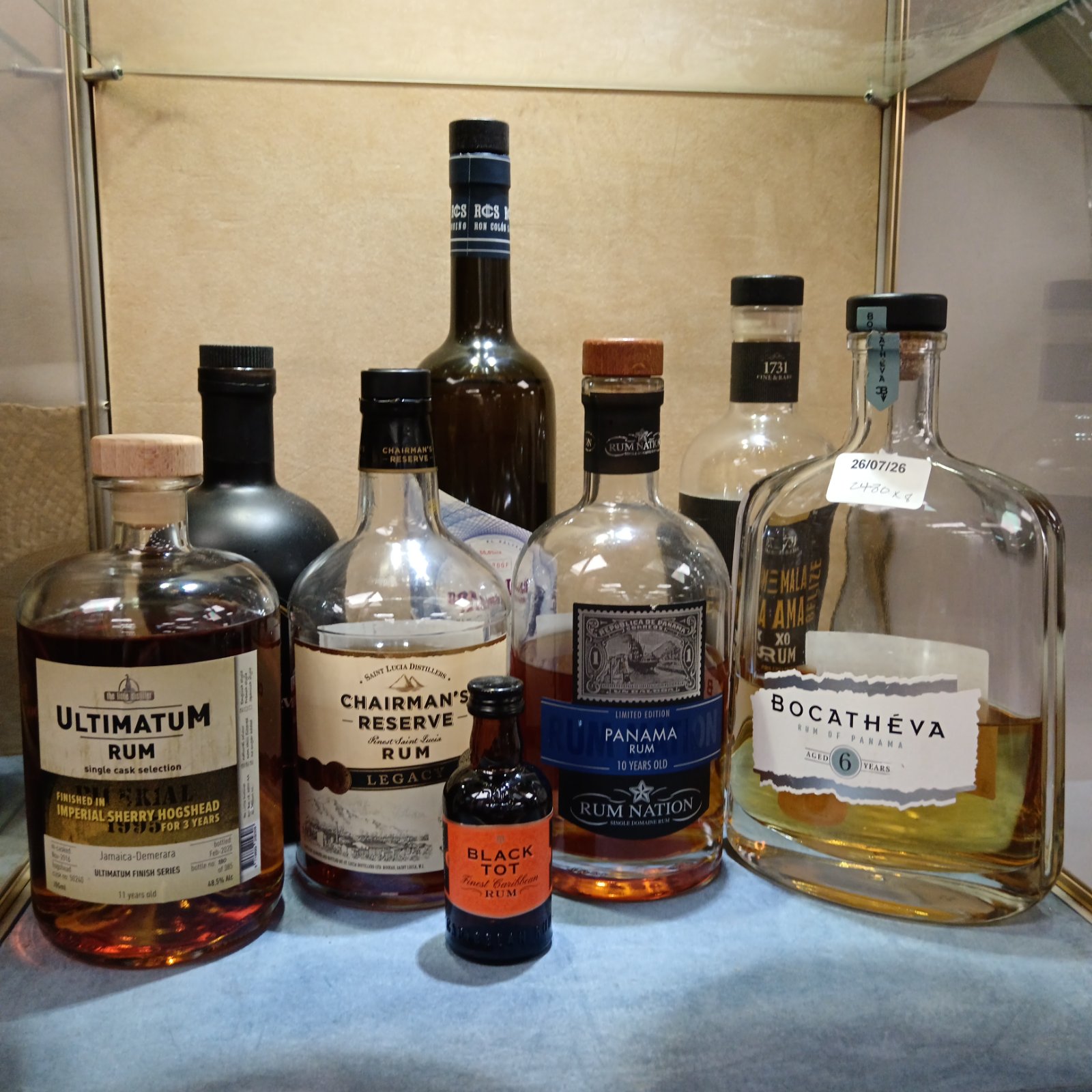 Collection of partially drunk rum bottles including Chairman's Reserve.