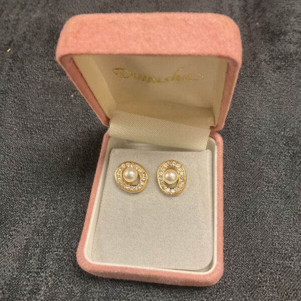 Vintage pearl stud earrings displayed in a velvet box.