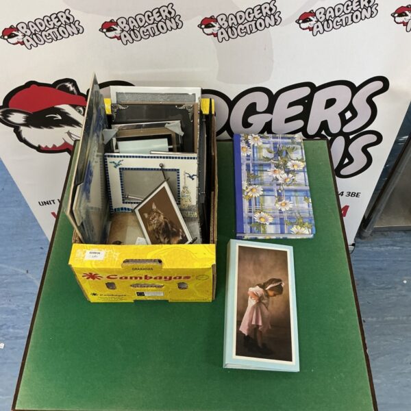 Lot of assorted photo frames and empty photo albums for display.