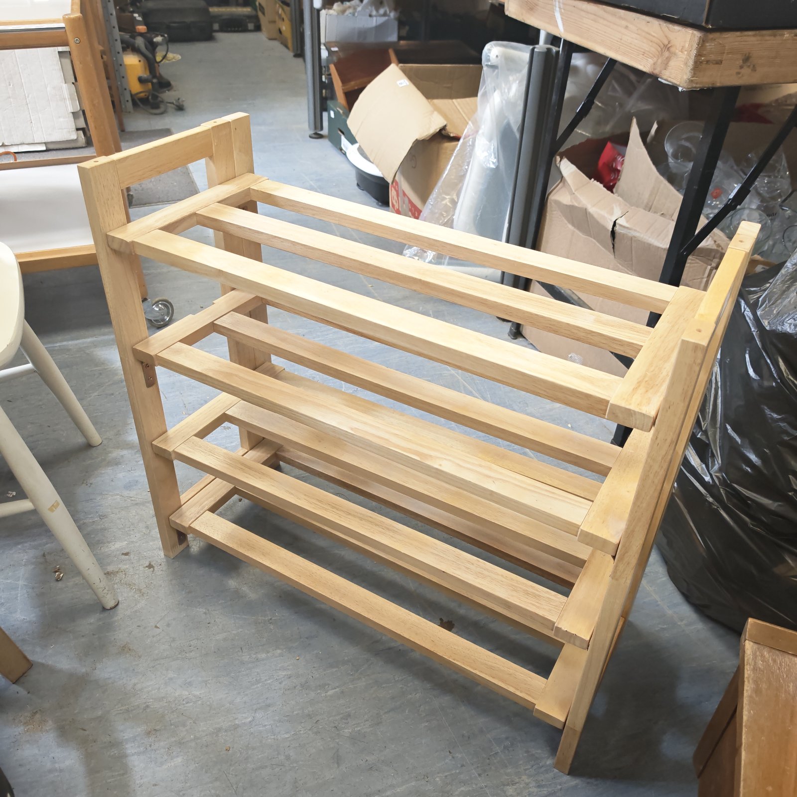 Wooden pine folding shoe rack for convenient shoe storage.