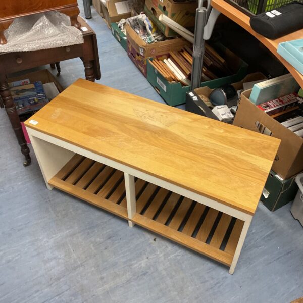 Rustic pine shoe rack bench with white supports.