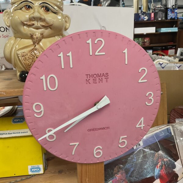 Pink Thomas Kent Greenwich wall clock with clear numerals.