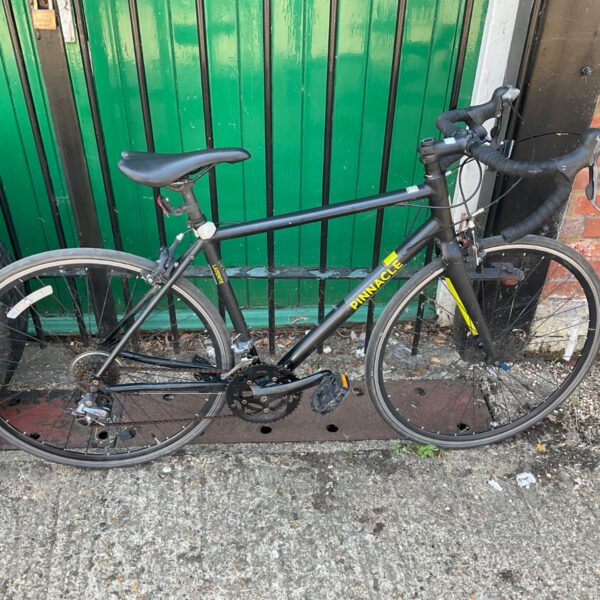 Black Pinnacle Laterite 1 road bike with yellow accents.