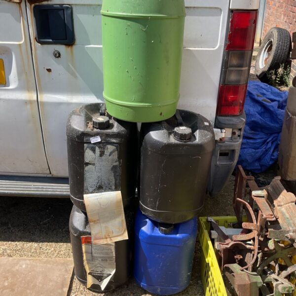 Lot of five empty plastic barrel containers for storage.