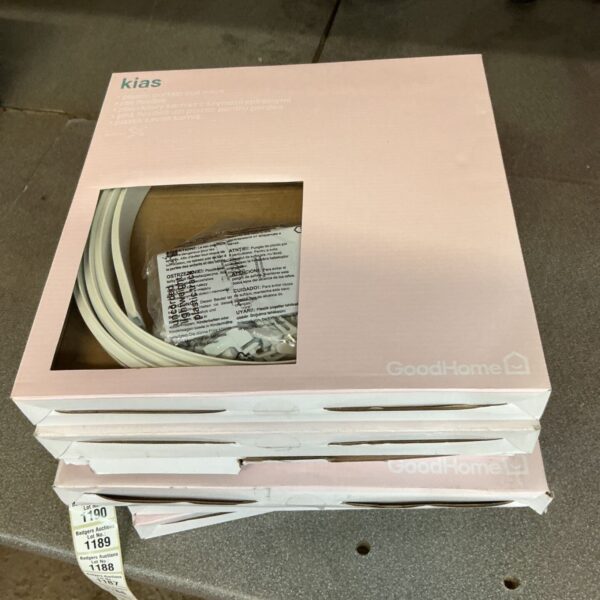 Four packs of unopened plastic curtain coil racks for window treatments.