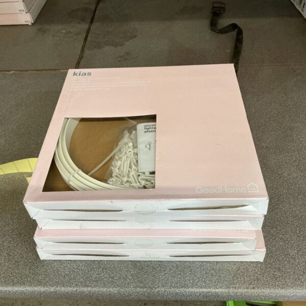 Four packs of unopened plastic curtain coil racks for window treatments.