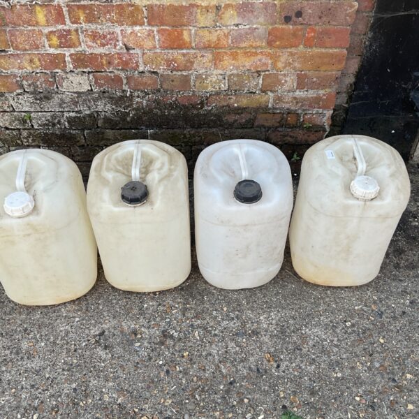 Four clear plastic liquid bottles for storage.
