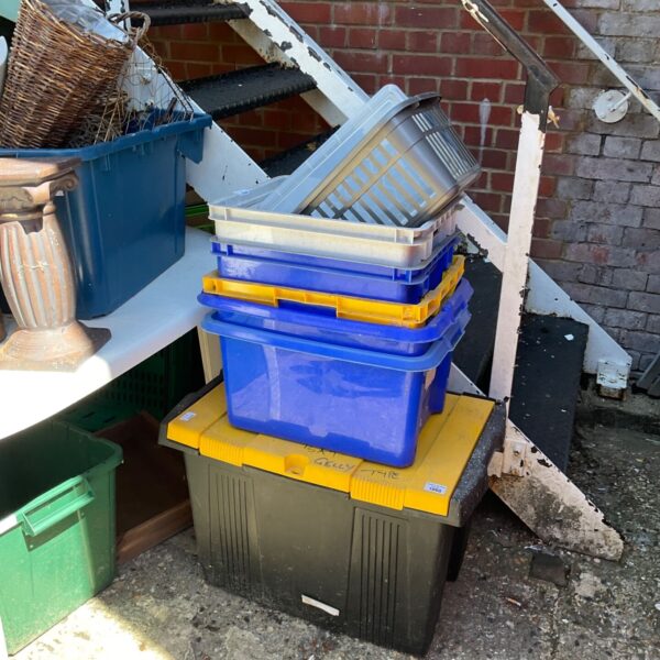 Assorted plastic storage containers stacked for household organisation.
