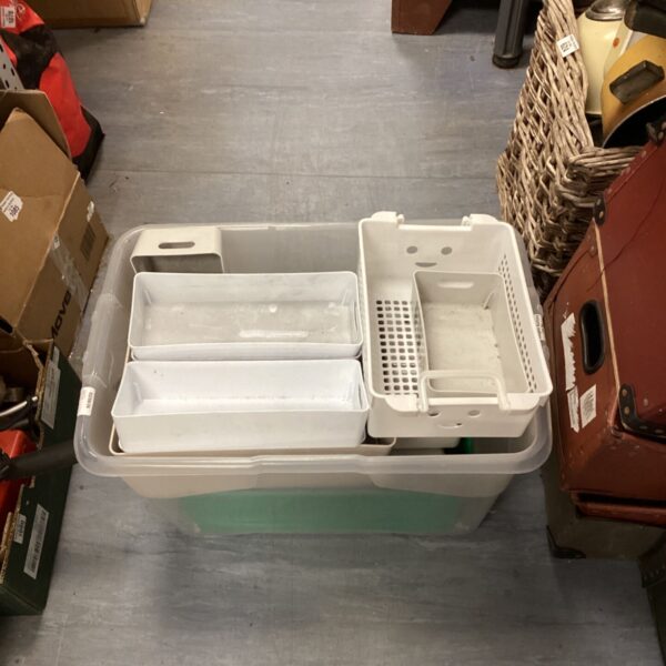 White plastic storage tubs in a collection, ideal for household organization.