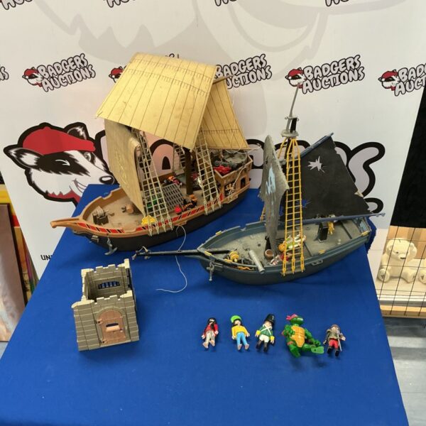 Vintage Playmobil pirate ship set with figures and sails.