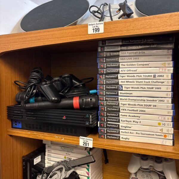 Sony PlayStation 2 console with games and accessories bundle.