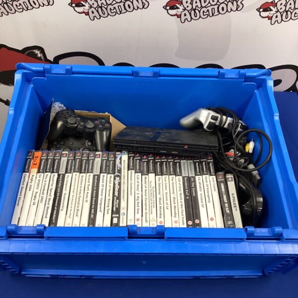 PlayStation 2 slim console with games and controllers bundle.