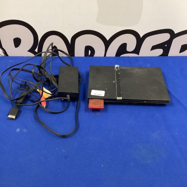 PlayStation 2 slim console with cables and memory card for retro gaming.