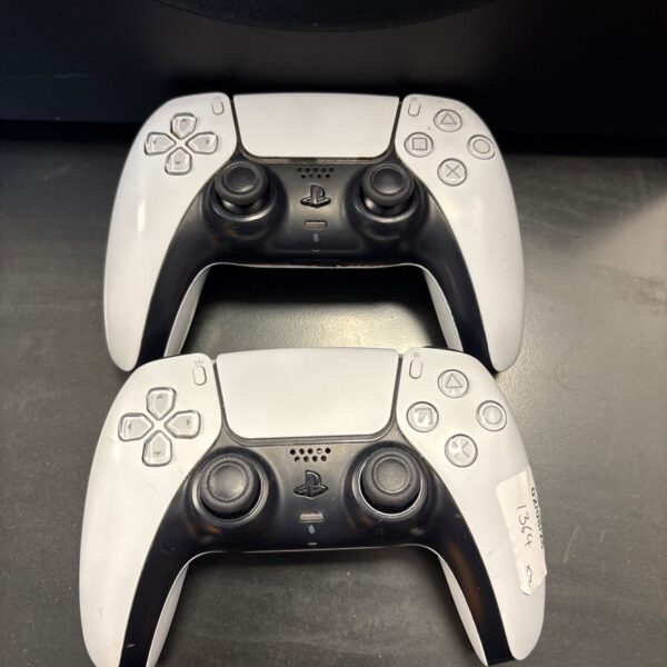Pair of used PlayStation DualSense controllers for PS5 gaming.