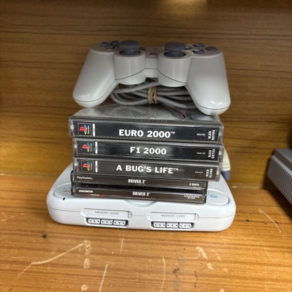 Sony PlayStation One slim console with games and controller.