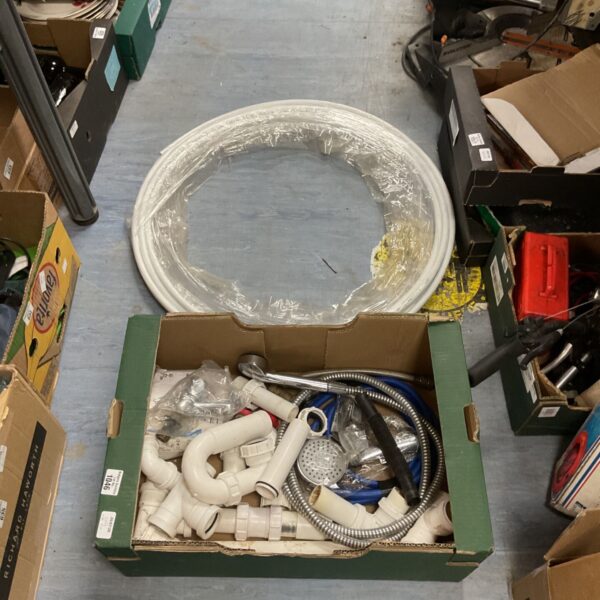 Assorted plumbing components including pipes and a shower head.