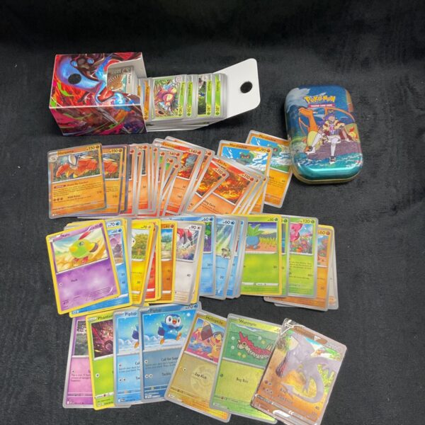 Assorted Pokemon cards in decorative tins, collectible trading card game.