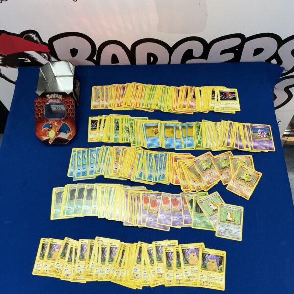 Pokémon trading card collection in a tin, featuring duplicate cards.