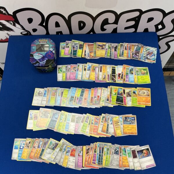 Pokémon trading card collection with a tin for storage.