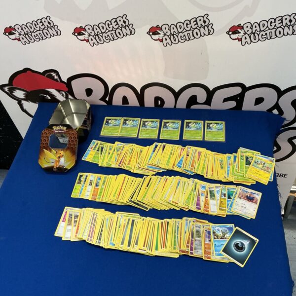 Large lot of Pokémon trading cards in a collector’s tin.