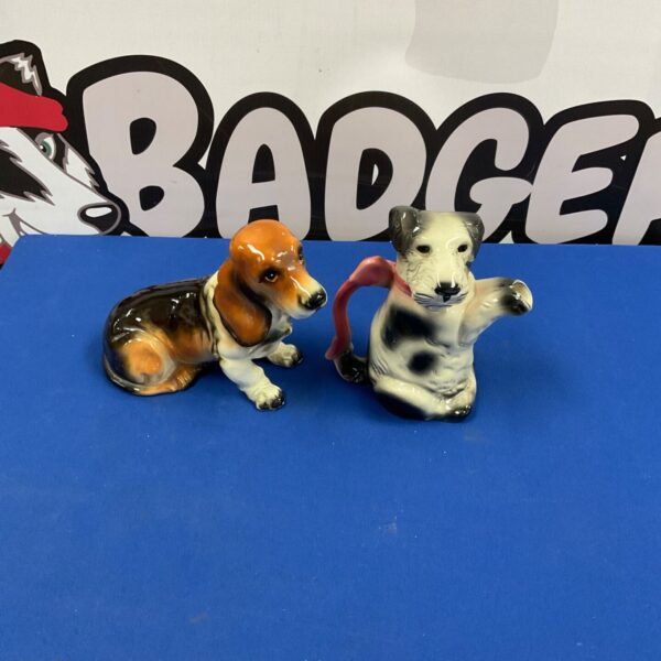 Vintage porcelain dog figurines, a Dachshund and terrier pair.