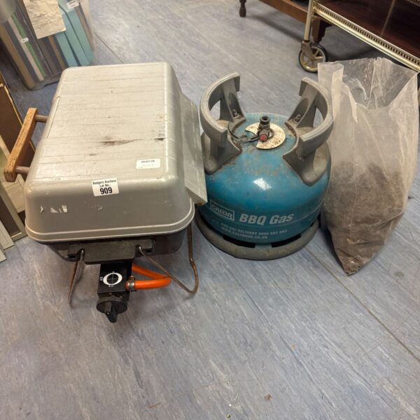 Portable BBQ set with gas canister for outdoor cooking.
