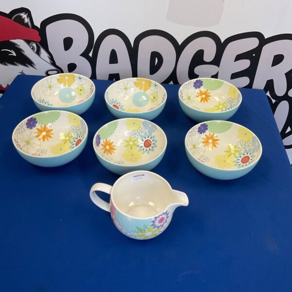 Portmeirion Crazy Daisy cereal bowls and milk jug set on display.