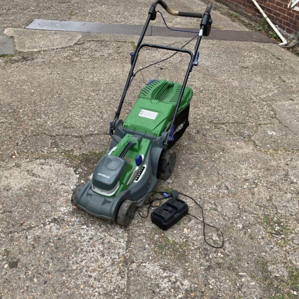 Powerbase cordless lawnmower with charger for garden maintenance.