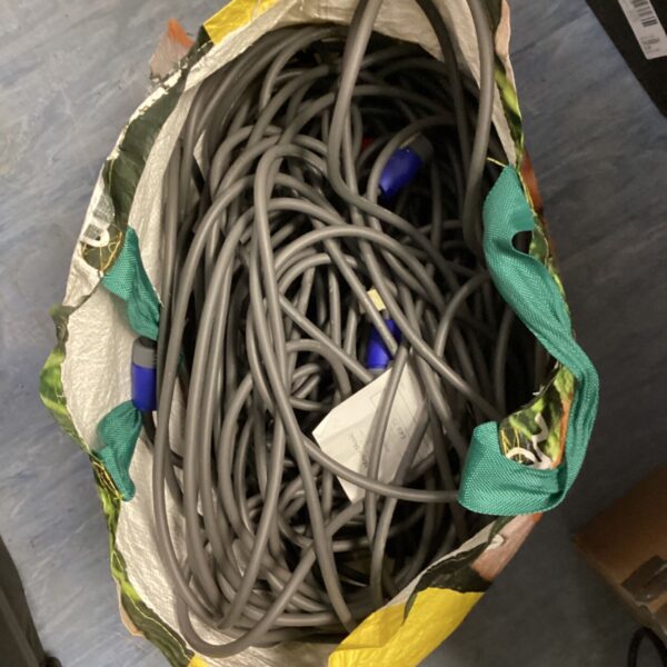 Overhead view of a bag filled with grey powerCON cables.