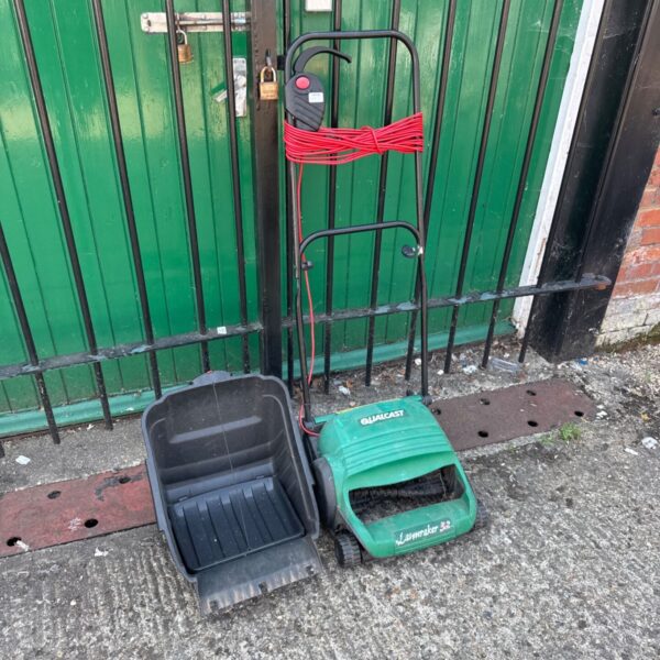 Used Qualcast Lawnraker 32 electric lawn rake for garden maintenance.