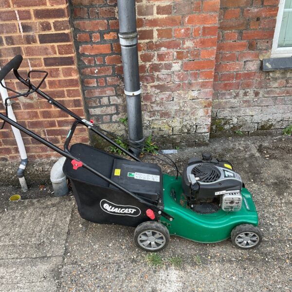 Qualcast XSS41D petrol lawnmower in a garden setting.