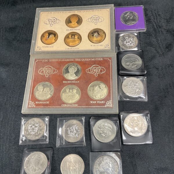 Queen Elizabeth The Queen Mother commemorative coin sets in plastic cases.