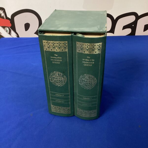 Vintage green hardcover Quran volumes, Islamic religious text.