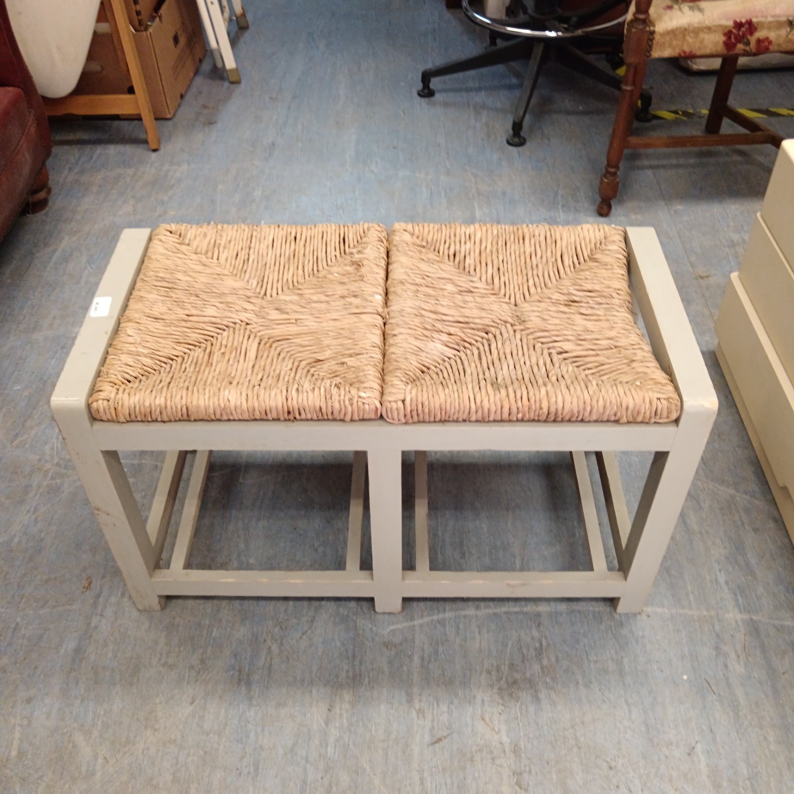 Pair of rustic rattan benches with wooden frames.