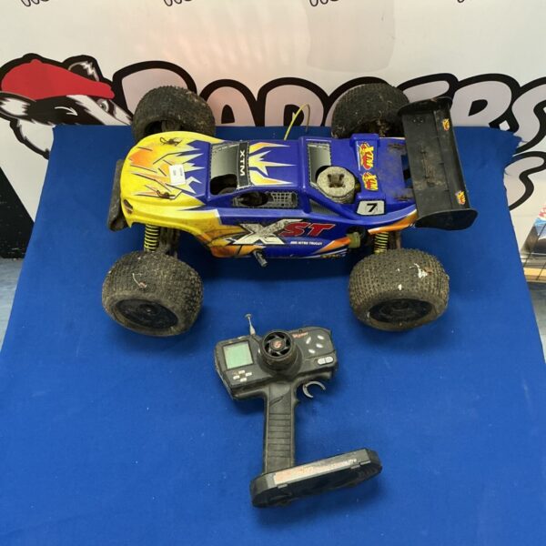 Blue RC XTM Nitro Truggy with remote control.